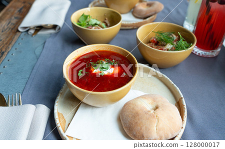 Borscht or borsch in bowl, Ukrainian beetroot soup. Red chowder thick borscht with sour cream 128000017
