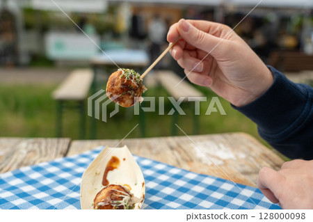 Takoyaki - traditional Japanese street food, Osaka outdoor snack with octopus, takoyaki fried balls 128000098