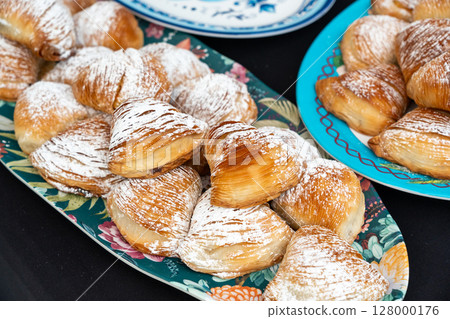Many sfogliatella cakes on street market. Sfogliatelle puff pastry, naples bakery Many sfogliatella cakes on street market. Sfogliatelle puff pastry, naples bakery 128000176