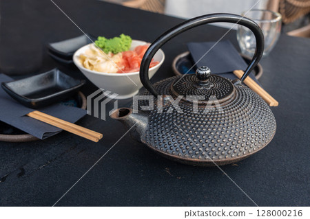 Japanese tea pot, black metal teapot, traditional iron kettle for tea drinking while waiting for sushi Japanese tea pot, black metal teapot, traditional iron kettle for tea drinking while waiting for sushi 128000216