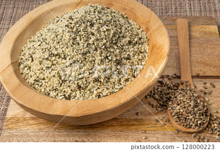 Shelled hemp seeds pile, peeled cannabis grains, marijuana kernels without peel 128000223