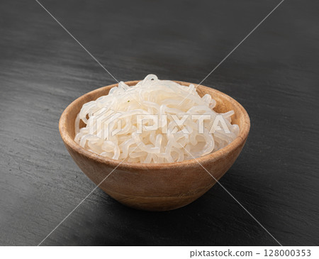 Shirataki or konnyaku pasta in wood bowl. Konjak jelly noodles, Japanese zero calorie sirataki Shirataki or konnyaku pasta in wood bowl. Konjak jelly noodles, Japanese zero calorie sirataki 128000353