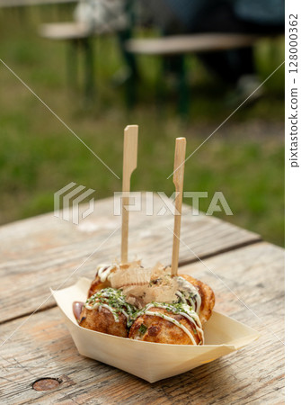 Takoyaki - traditional Japanese street food, outdoor snack with octopus Takoyaki fried balls Takoyaki - traditional Japanese street food, outdoor snack with octopus Takoyaki fried balls 128000362