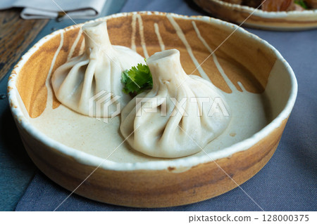 Georgian khinkali or chinkali with minced meat. Traditional spicy Georgian steamed dumplings Georgian khinkali or chinkali with minced meat. Traditional spicy Georgian steamed dumplings 128000375