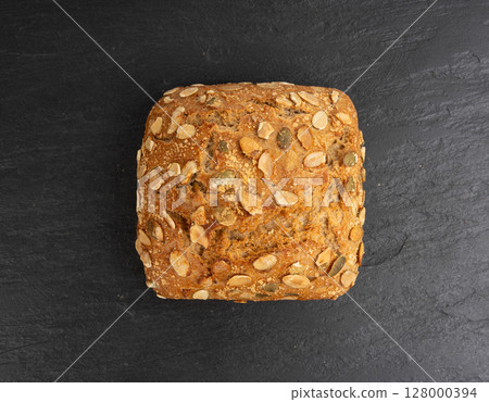 Pumpkin seeds bread, breakfast roll with pepita seeds. Fitness square bun, healthy burger 128000394