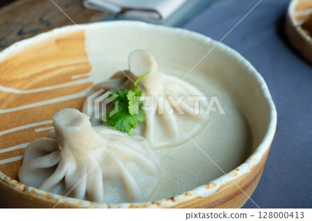 Georgian khinkali or chinkali with minced meat. Traditional spicy Georgian steamed dumplings 128000413
