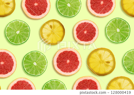 Top view of citrus fruit slices including lime, lemon, and grapefruit 128000419