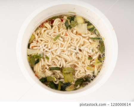 Dry instant noodles in cup isolated. Raw spaghetti in a plastic cup, fast food pasta in container Dry instant noodles in cup isolated. Raw spaghetti in a plastic cup, fast food pasta in container 128000614