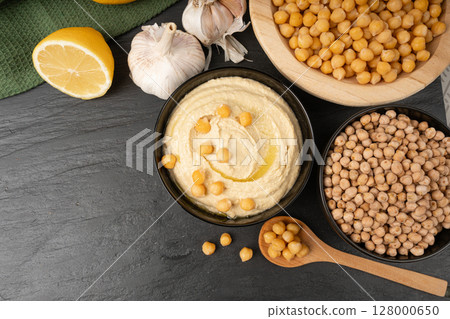 Hummus in bowl, houmous dip, chickpea humus tahini sauce, middle eastern spread Hummus in bowl, houmous dip, chickpea humus tahini sauce, middle eastern spread 128000650