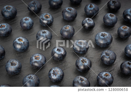 Blueberry texture background. Fresh blue berry fruits pattern, bilberry wallpaper with copy space Blueberry texture background. Fresh blue berry fruits pattern, bilberry wallpaper with copy space 128000658