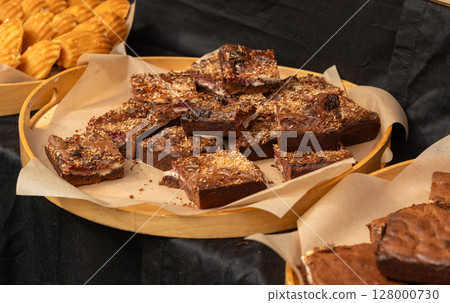 Brownie pile on paper. Chocolate cakes stack, homemade square dessert with fudge Brownie pile on paper. Chocolate cakes stack, homemade square dessert with fudge 128000730
