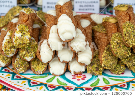 Cannoli with pistachios and ricotta. Sicilian dessert cannolo, fresh sweet cannoli pile Cannoli with pistachios and ricotta. Sicilian dessert cannolo, fresh sweet cannoli pile 128000760