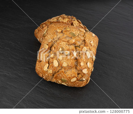 Pumpkin seeds bread, breakfast roll with pepita seeds. Fitness square bun, healthy burger Pumpkin seeds bread, breakfast roll with pepita seeds. Fitness square bun, healthy burger 128000775