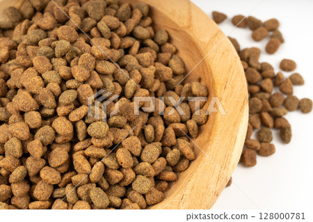 Dry pet food close up, dog kibble pile in wood bowl, puppy pellets macro, small canine protein Dry pet food close up, dog kibble pile in wood bowl, puppy pellets macro, small canine protein 128000781