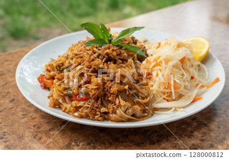 Pad thai or phad tha asian noodles closeup. Chinese rice pasta, phat thai with meat, noodles 128000812