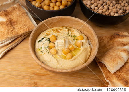 Hummus in bowl, houmous dip, chickpea humus tahini sauce, middle eastern spread 128000828