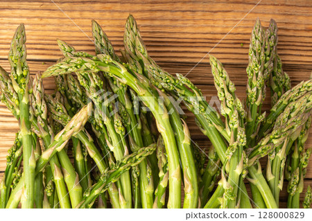 Bunch of Raw Garden Asparagus on Wood Rustic Tabletop. Fresh Green Spring Vegetables Bunch of Raw Garden Asparagus on Wood Rustic Tabletop. Fresh Green Spring Vegetables 128000829