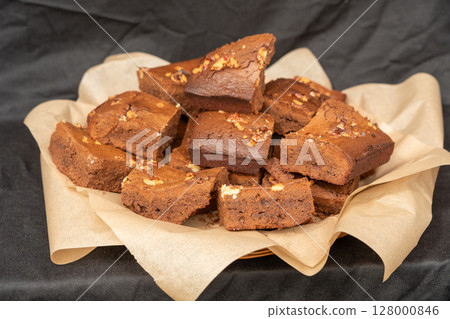Brownie pile on paper. Chocolate cakes stack, homemade square dessert with fudge Brownie pile on paper. Chocolate cakes stack, homemade square dessert with fudge 128000846