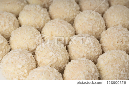 Coconut candies texture background, coco balls pattern. White truffle ball wallpaper, indian ladoo 128000856