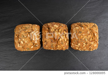 Pumpkin seeds bread, breakfast roll with pepita seeds. Fitness square bun, healthy burger 128000895