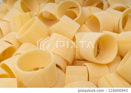 Raw Calamarata Big Pasta Isolated, Homemade Dry Macaroni, Italian Raw Round Noodle Raw Calamarata Big Pasta Isolated, Homemade Dry Macaroni, Italian Raw Round Noodle 128000943