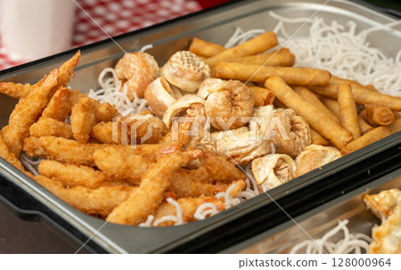 Deep fry seafood set with calamari rings, crispy gyoza dumplings, shrimps and spring rolls Deep fry seafood set with calamari rings, crispy gyoza dumplings, shrimps and spring rolls 128000964