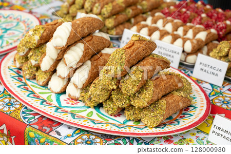 Cannoli with pistachios and ricotta. Sicilian dessert cannolo, fresh sweet cannoli pile 128000980