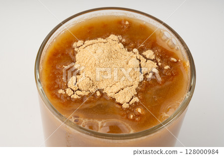 Maca powder drink isolated, dry Peruvian ginseng beverage, powder in water, ground ayak willku tea 128000984
