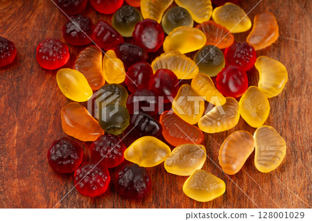 Fruit gummy candy pile, vegan chewing marmalade pills, jelly gumdrops heap Fruit gummy candy pile, vegan chewing marmalade pills, jelly gumdrops heap 128001029