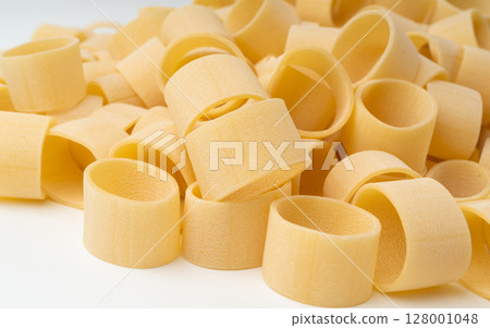 Raw Calamarata Big Pasta Isolated, Homemade Dry Macaroni, Italian Raw Round Noodle 128001048