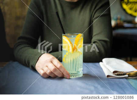 Ice lemonade in tall glass. Yuzu mocktail with lemon and soda, cool lime juice cocktail 128001086