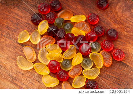 Fruit gummy candy pile, vegan chewing marmalade pills, jelly gumdrops heap Fruit gummy candy pile, vegan chewing marmalade pills, jelly gumdrops heap 128001134