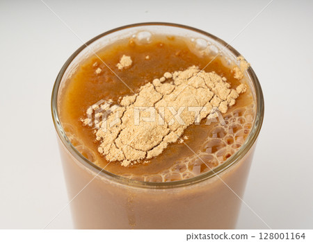 Maca powder drink isolated, dry Peruvian ginseng beverage, powder in water, ground ayak willku tea 128001164