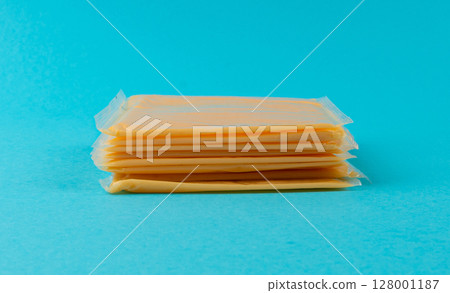 American cheese, processed cheese slice, wrapped thin yellow cheddar in a plastic package 128001187