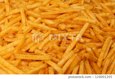 Fried chips sticks texture background, finger potato ketchup flavored chips pattern, shoestring fries 128001205
