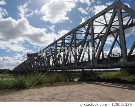 The sky flowing behind the steel beams - a distant view of Burdekin Bridge 128001329