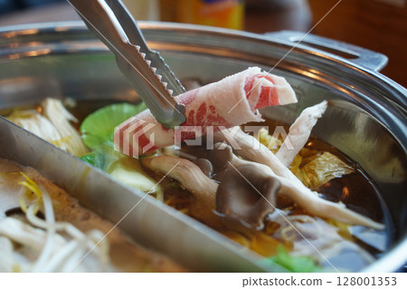 Hot Pot with Thinly Sliced Meat and Fresh Vegetables. Close-Up of Cooking Moment 128001353