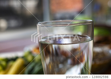 Glass of pure water on the dining table. Glass of pure water on the dining table. 128002598