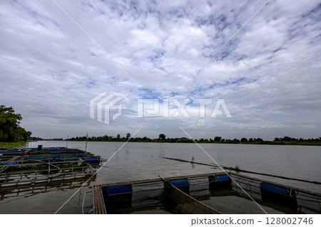 Riverside Atmosphere in Manorom District, Chai Nat Province, Background for advertising and wallpaper in natural environment and nature scene. Fish Farm By The River. 128002746