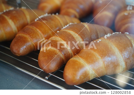 Close-Up of Freshly Baked Salt Butter Rolls with Crusty Surface and Sea Salt on Top Close-Up of Freshly Baked Salt Butter Rolls with Crusty Surface and Sea Salt on Top 128002858