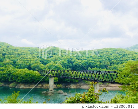 A beautiful iron bridge over a dam lake A beautiful iron bridge over a dam lake 128003015