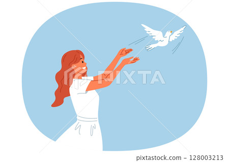 Woman launches dove into sky, symbolizing peace and harmony or hope for better future for people 128003213