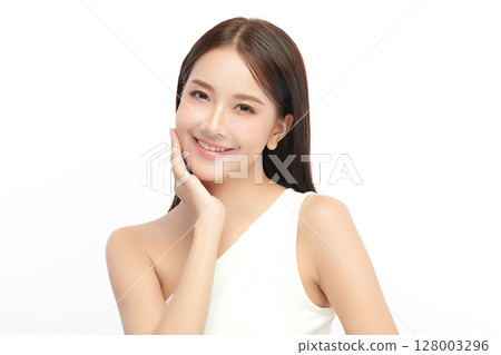 A beautiful young Asian woman with clean, fresh skin against a white background. Skincare, facial treatment, cosmetology, beauty, and spa. An elegant portrait of an Asian woman. 128003296