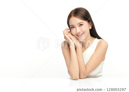 A beautiful young Asian woman with clean, fresh skin against a white background. Skincare, facial treatment, cosmetology, beauty, and spa. An elegant portrait of an Asian woman. 128003297