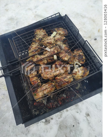 T-Bone Steak on Barbecue Grill Flames 128003416