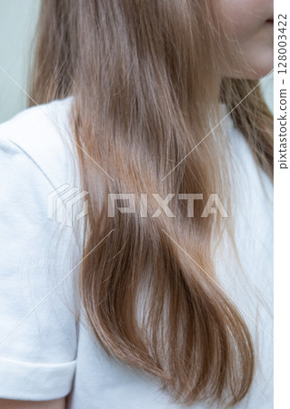 Young woman with long, dark blonde hair pulled back in a low ponytail. Casual hairstyle. Sporty hairstyle. Running hairstyle. Young woman with long, dark blonde hair pulled back in a low ponytail. Casual hairstyle. Sporty hairstyle. Running hairstyle. 128003422