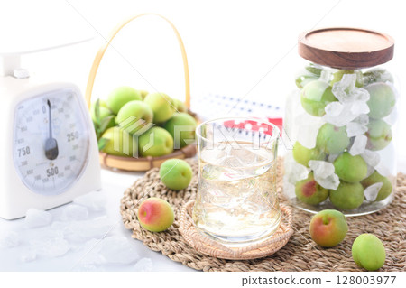 Homemade plum juice and preserved green plums in a jar. Refreshing summer drink photo (plum syrup) 128003977