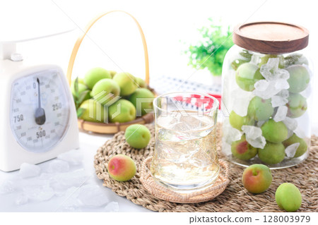 Homemade plum juice and preserved green plums in a jar. Refreshing summer drink photo (plum syrup) Homemade plum juice and preserved green plums in a jar. Refreshing summer drink photo (plum syrup) 128003979