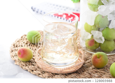 Homemade plum juice and preserved green plums in a jar. Refreshing summer drink photo (plum syrup) Homemade plum juice and preserved green plums in a jar. Refreshing summer drink photo (plum syrup) 128003988