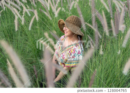 Woman (LGBTQ) posing at flower park garden field 128004765